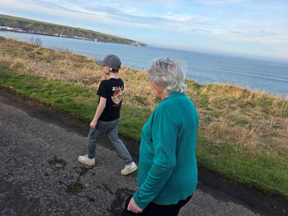 Reena Warren walks with young friend, Owen Sinclair.