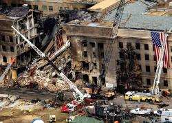 This image taken on September 14, 2001, shows FBI agents, firefighters, rescue workers and engineers working at the Pentagon crash site where the highjacked American Airlines flight slammed into the building. The terrorist attack caused extensive damage t