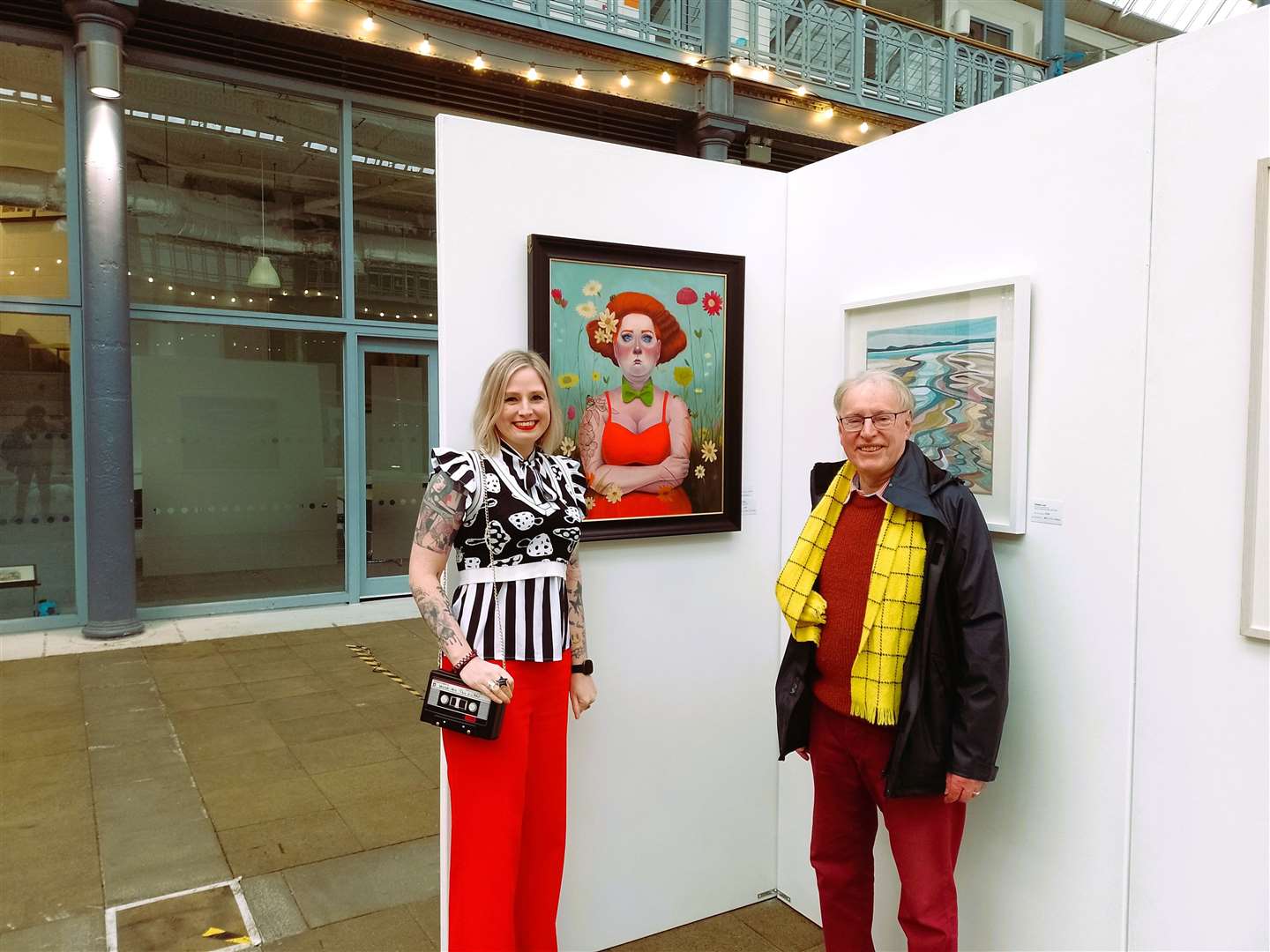 Leah Davis stands beside Ian Pearson who is chair of the Society of Caithness Artists and her highly commended painting Lady of the Flowers. Picture supplied