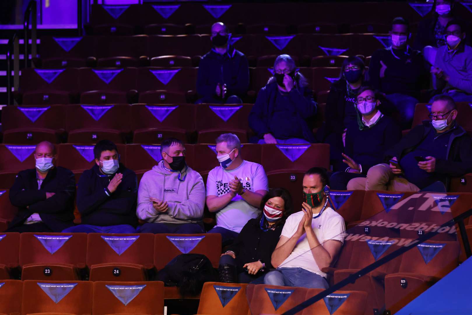 Spectators wearing face masks applaud during the Betfred World Snooker Championships (George Wood/PA)