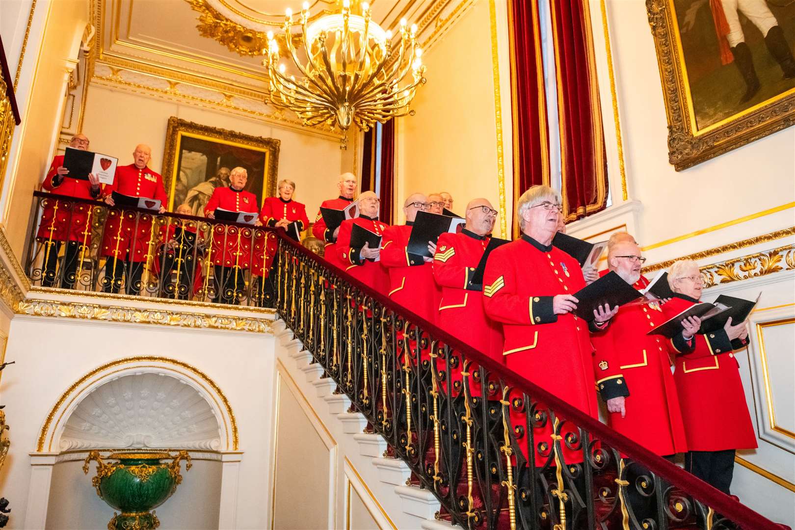 Chelsea Pensioners lined up on the stairs to sing Christmas carols.