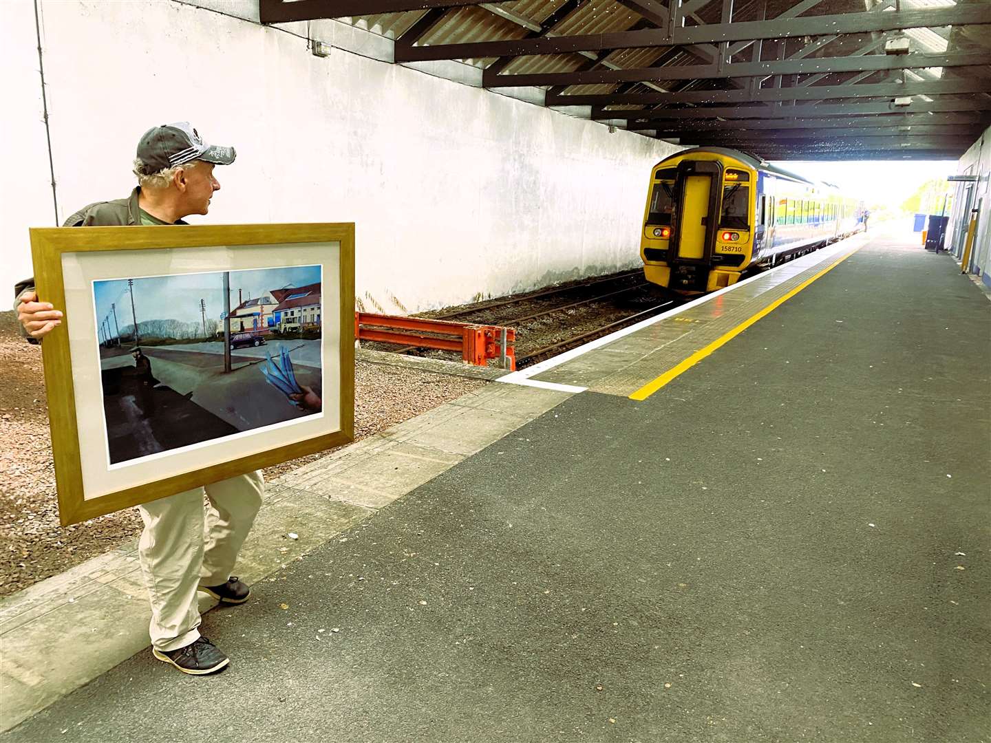 Ian C Scott with the work he donated to Wick Railway Station to commemorate its 150th birthday. Picture supplied