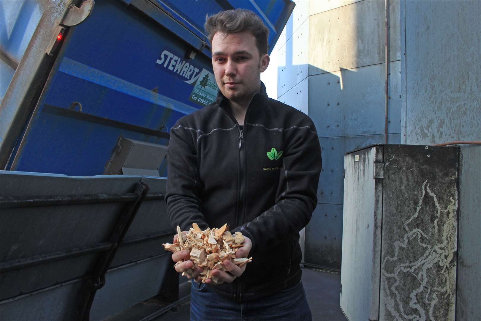 Ignis Wick Ltd manager Harris Gilmore with a handful of newly delivered wood chip. Picture: Alan Hendry