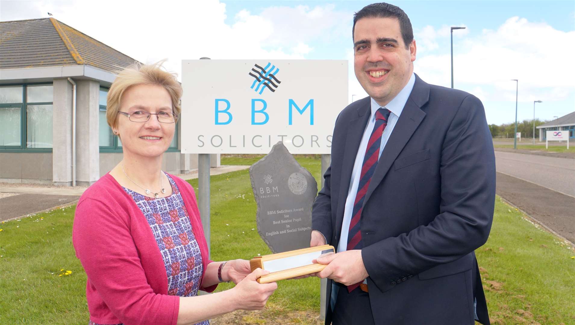 Fiona Grant and Eric Baijal holding the trophy outside the BBM Solicitors office at Wick Business Park. Picture: DGS