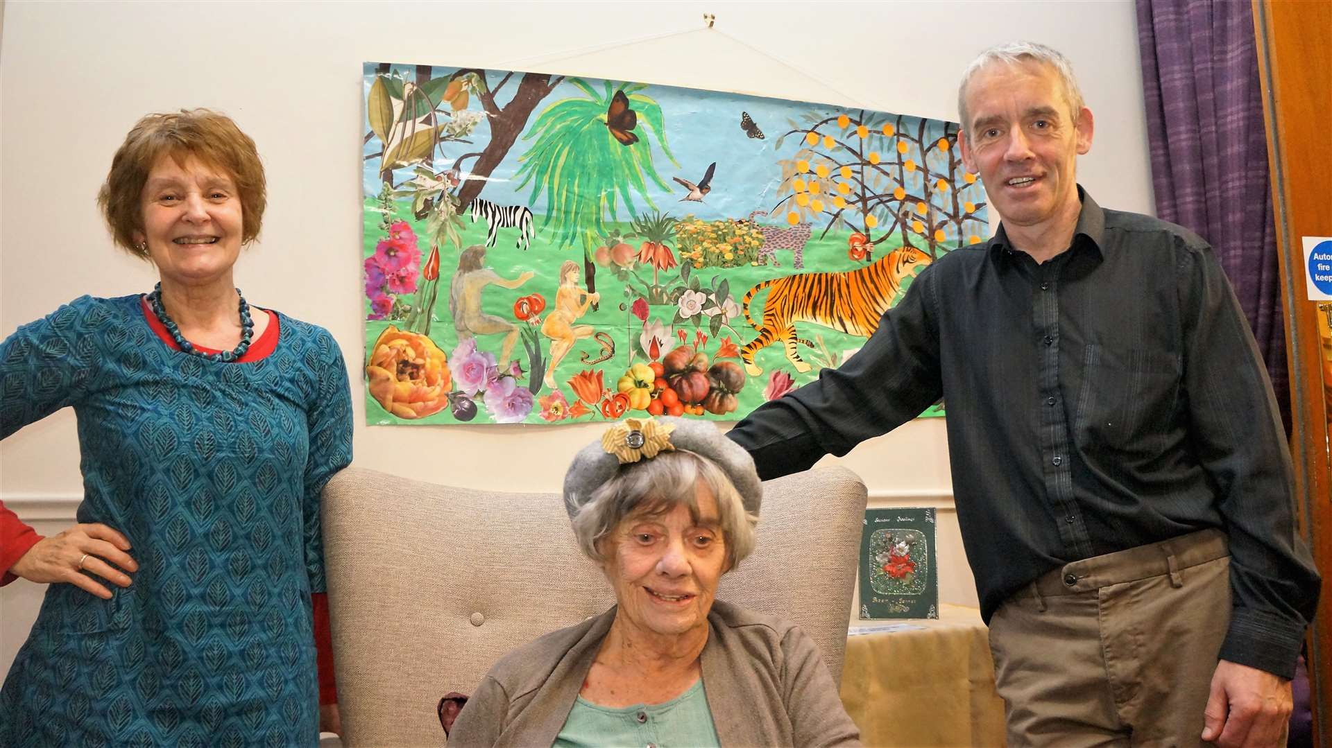 Joan Powell's befriender Dorothy Woodall, left, alongside Joan and her son Gavin Powell who lives in Halkirk. Behind them is a collage by Joan called Adam and Eve which is one of her favourite pieces. Pictures: DGS