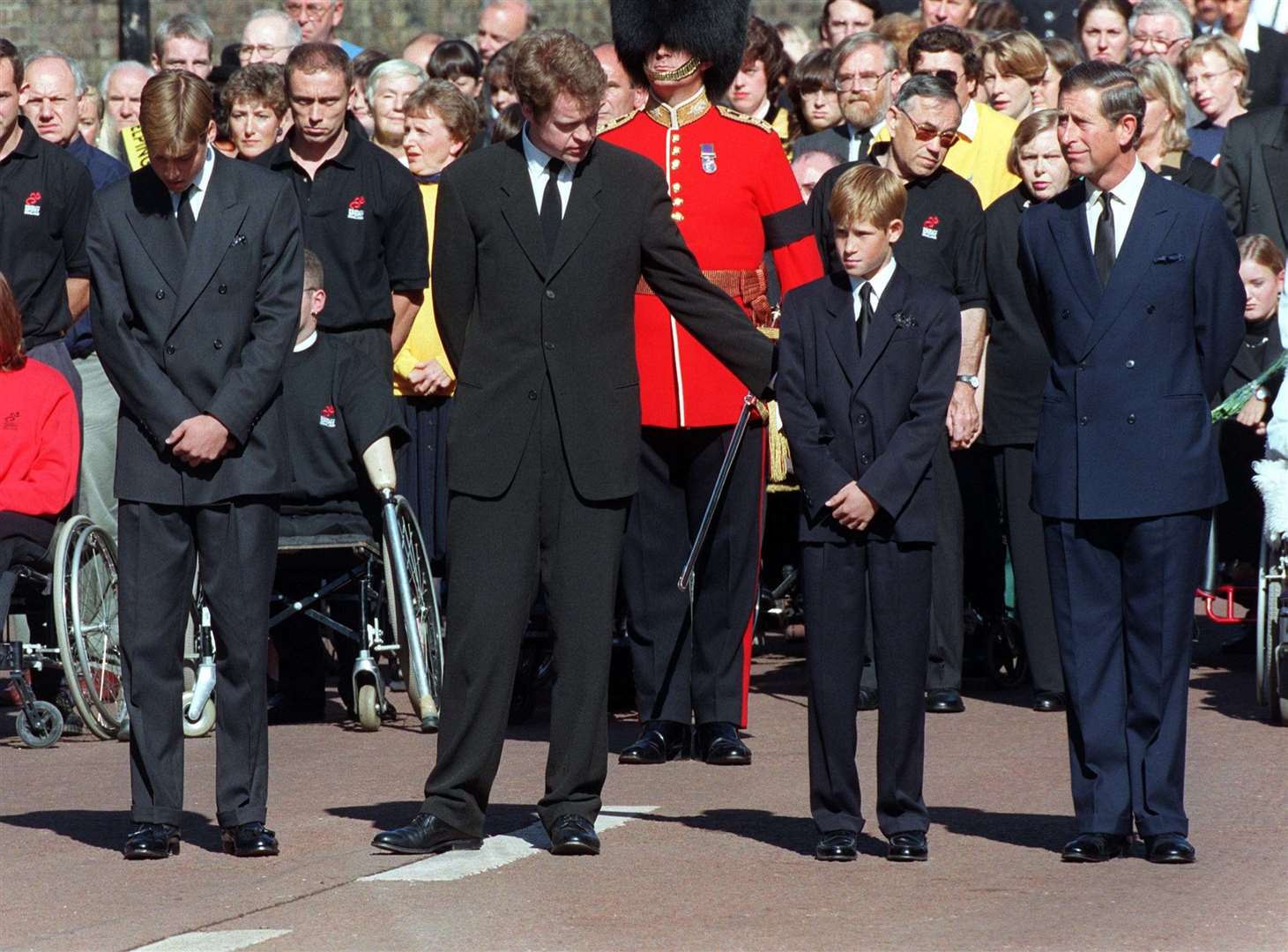 Earl Spencer (centre) offers Prince Harry a reassuring arm during Diana’s funeral procession (David Giles/PA)