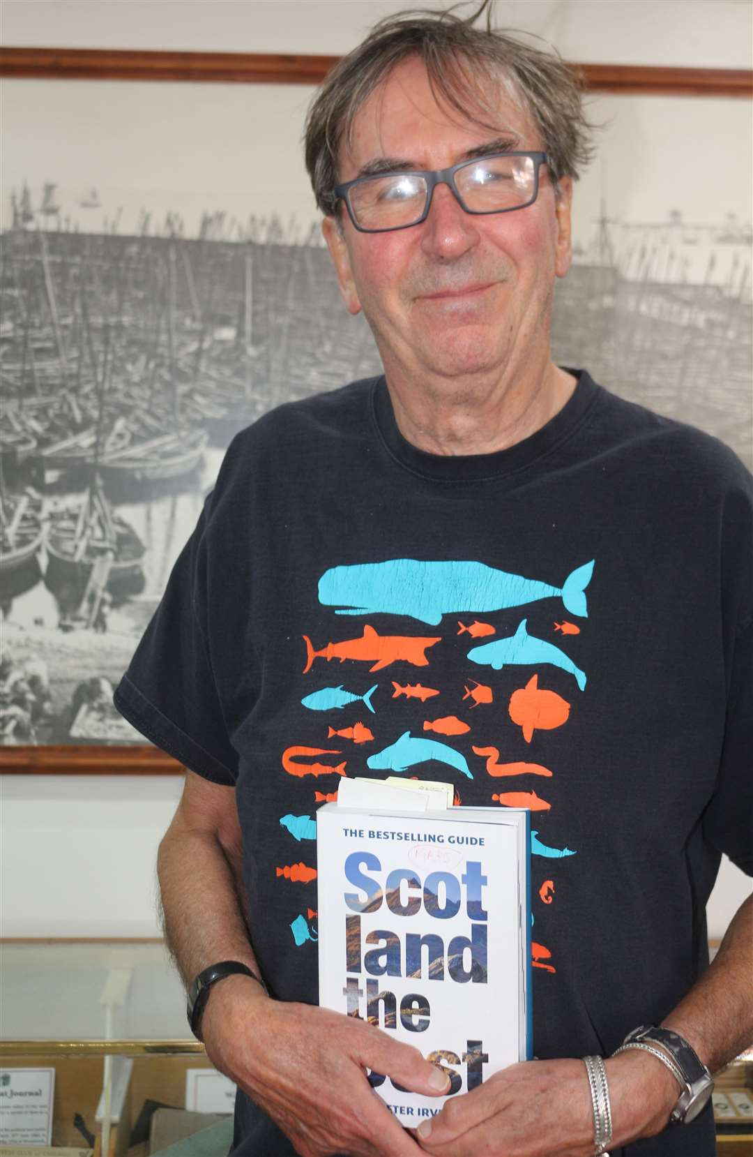 Author Peter Irvine in Wick Heritage Museum with a copy of his book. Picture: Eswyl Fell