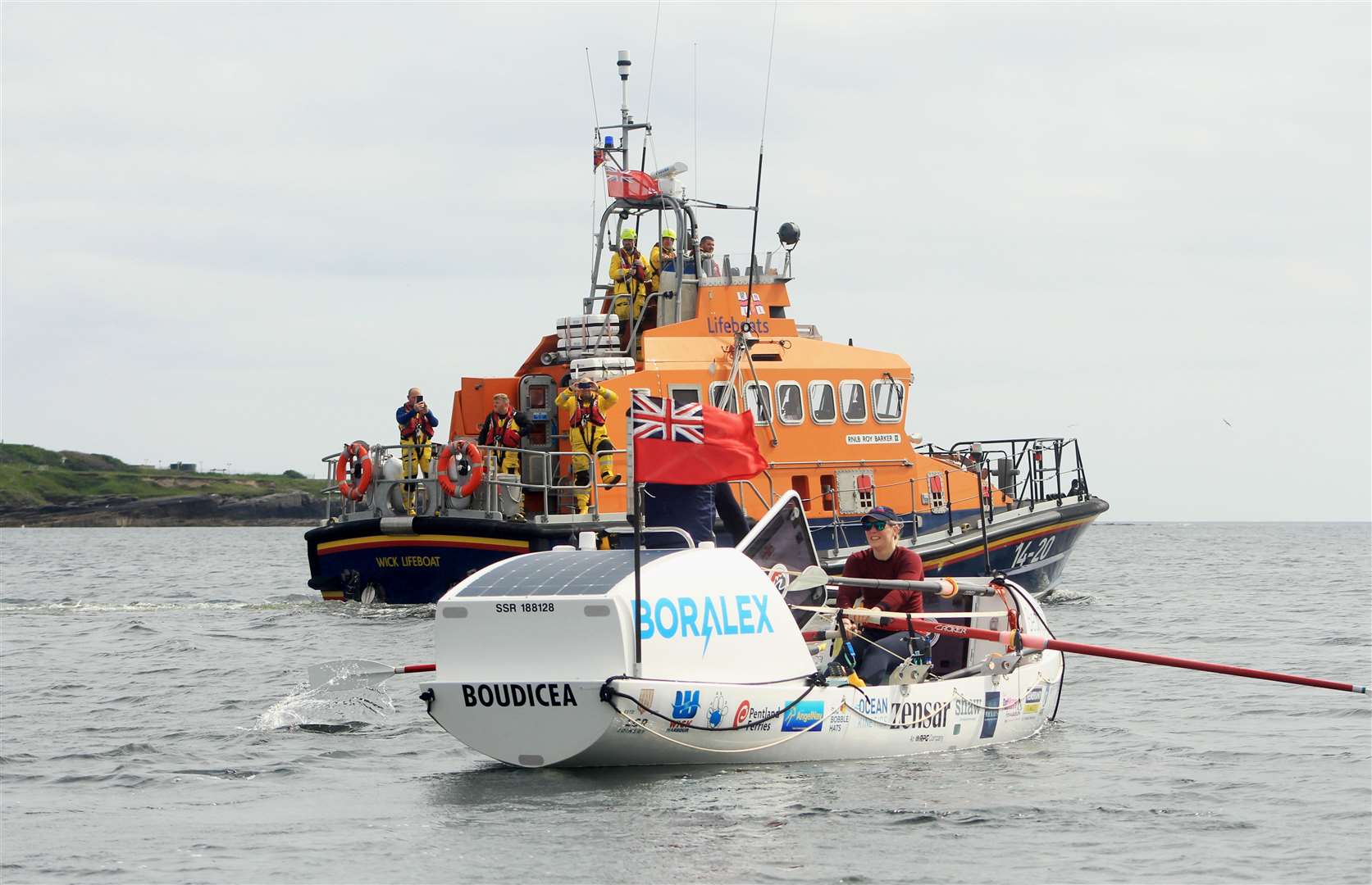 Mhairi Ross at the oars with Wick lifeboat alongside. Picture: Alan Hendry