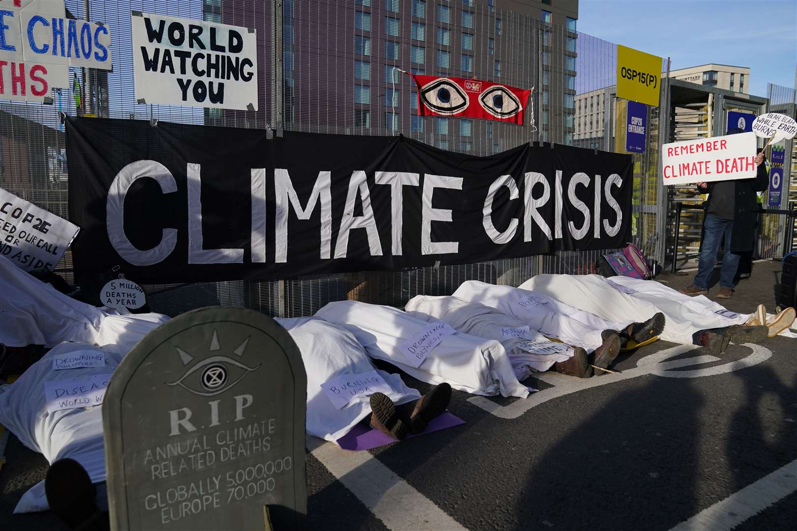 Climate protesters stage a die-in protest outside the Cop26 venue (Andrew Milligan/PA)
