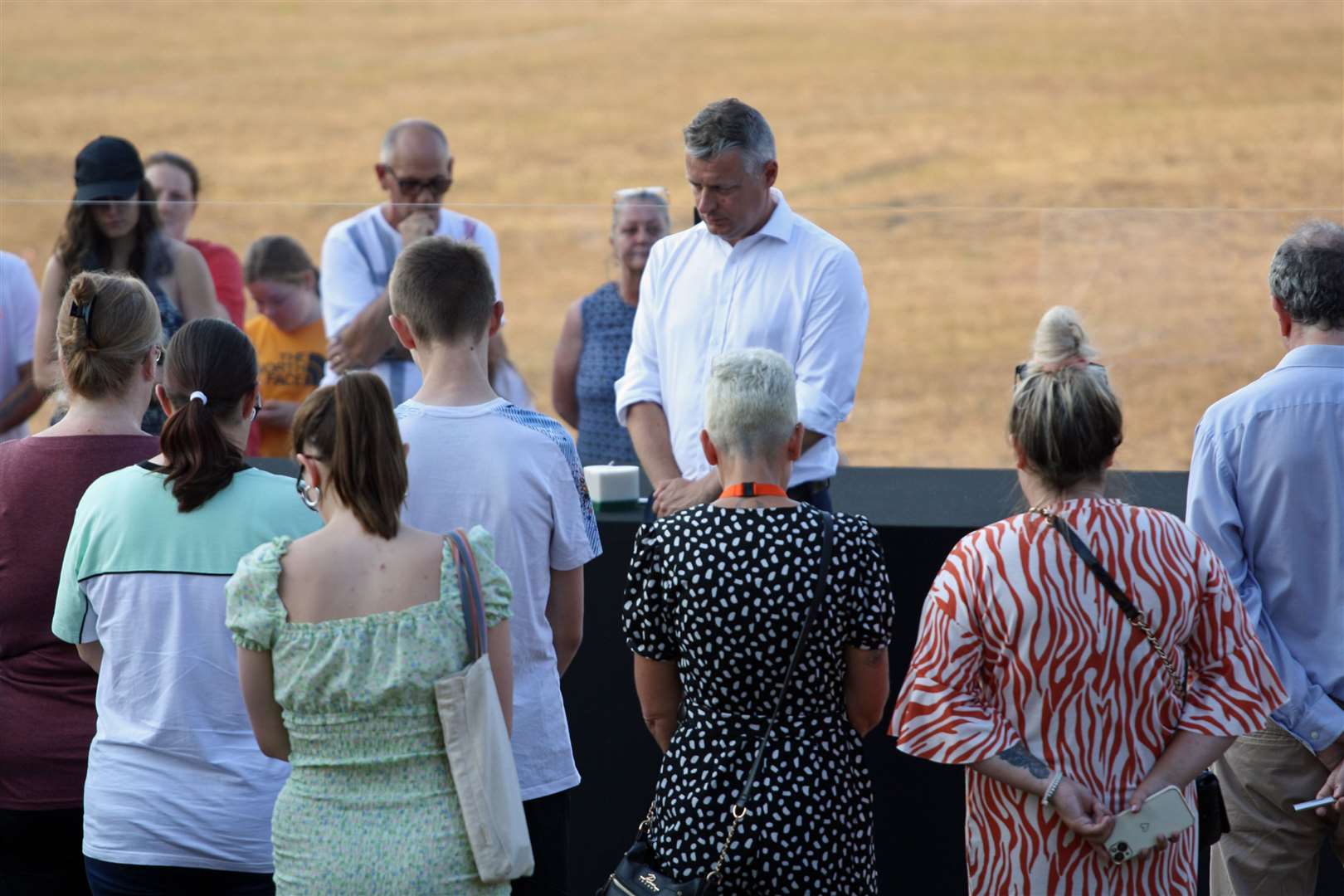 Local MP Luke Pollard and members of the public hold a minute’s silence during a vigil at North Down Crescent Park in Keyham (Rod Minchin/PA)
