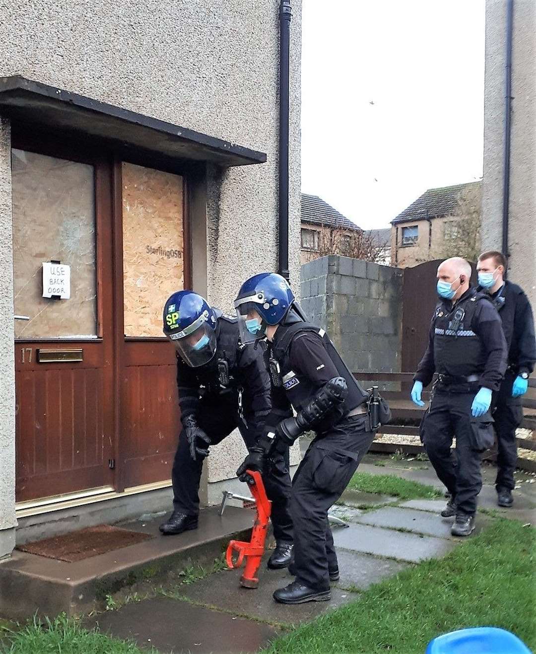 A special squad of officers approach the suspect's house in Thurso.