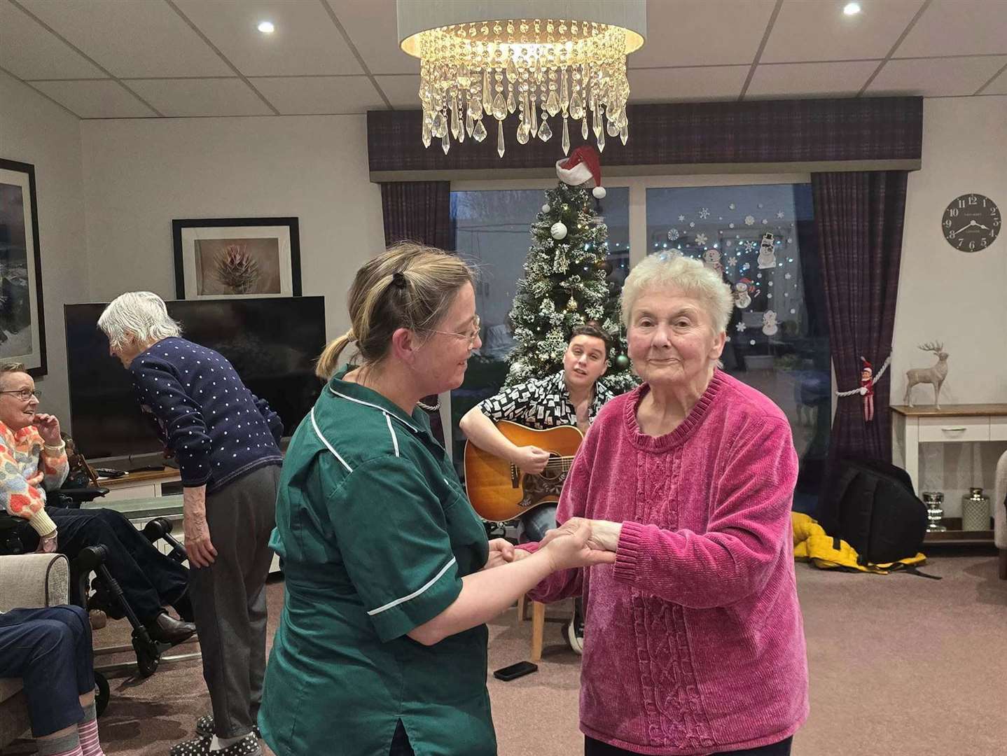 Resident Isabella Trueman dances with carer Trudi Cambridge.