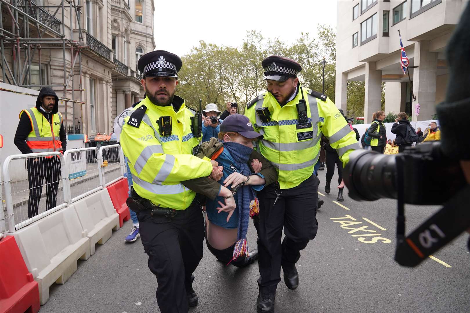 Police remove an activist during the protest (Lucy North/PA)