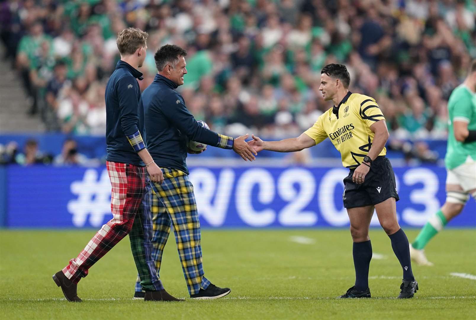 Hamish Weir, the son of the late Doddie Weir and Kenny Logan present the match ball (Andrew Matthews/PA)