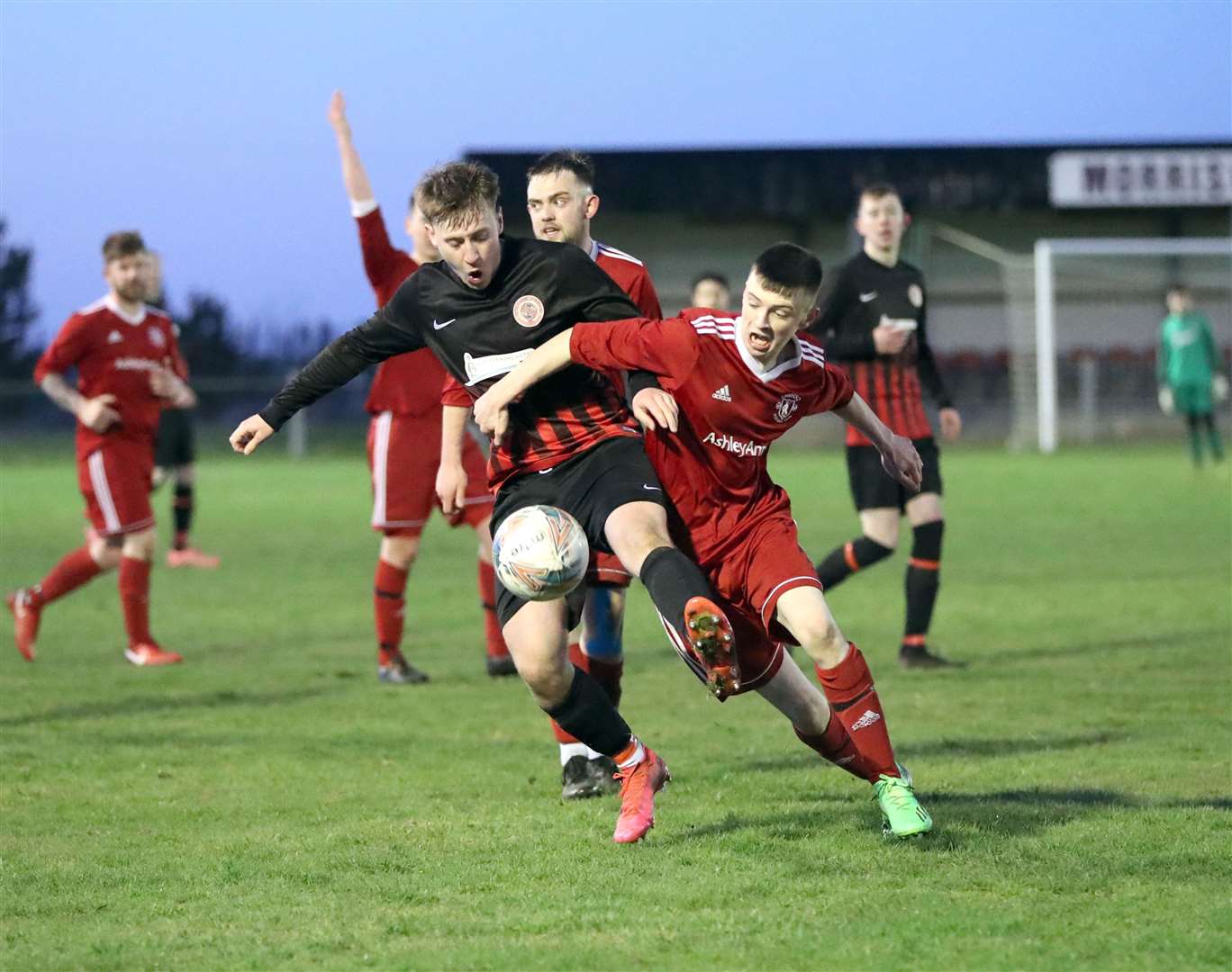 Sam Barclay of Halkirk United shields the ball from Thurso's Dylan Alexander during the Friday night clash at Morrison Park. Picture: James Gunn