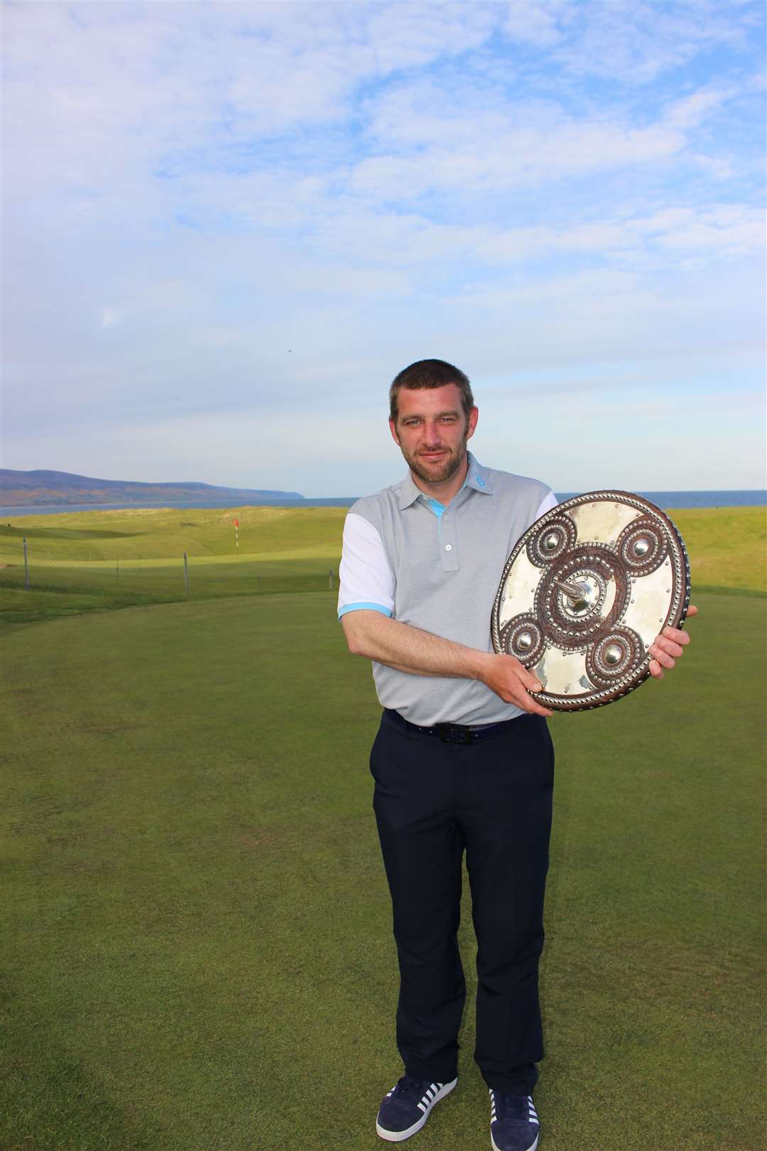 Wick’s Dougie Thorburn gets his turn to hold the Dornoch Firth League Targe after Brora’s win.