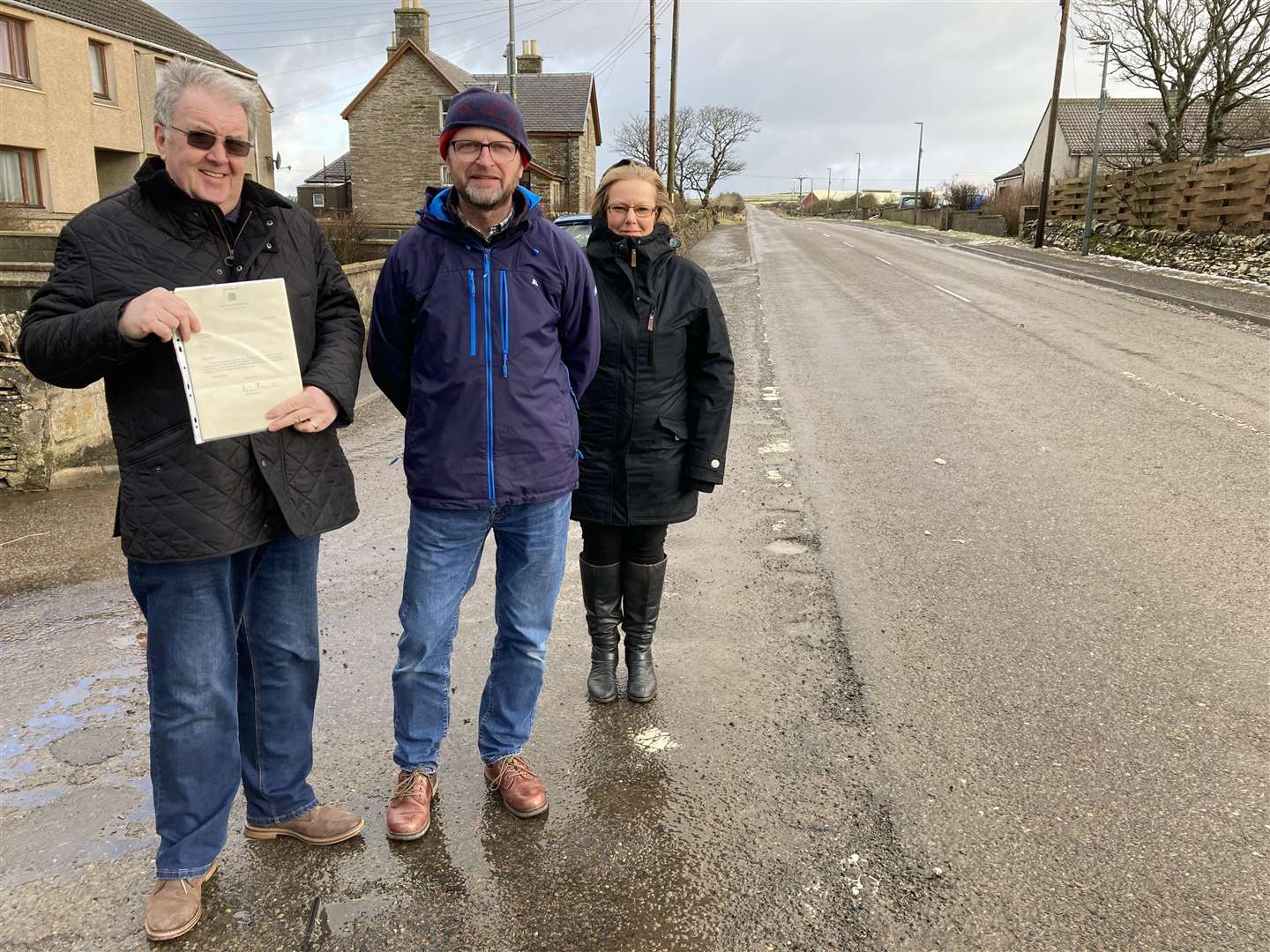 Councillor Matthew Reiss (centre) with Forss residents John Ross and Julie Minchin. Mr Ross is holding a Forss speed limit petition Lord Thurso gave to Councillor Reiss after he was first elected in 2013. Picture: Alison Reiss