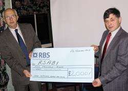 NFU Scotland chairman Arnott Coghill presents the cheque to RSABI chief executive Maurice Hankey.