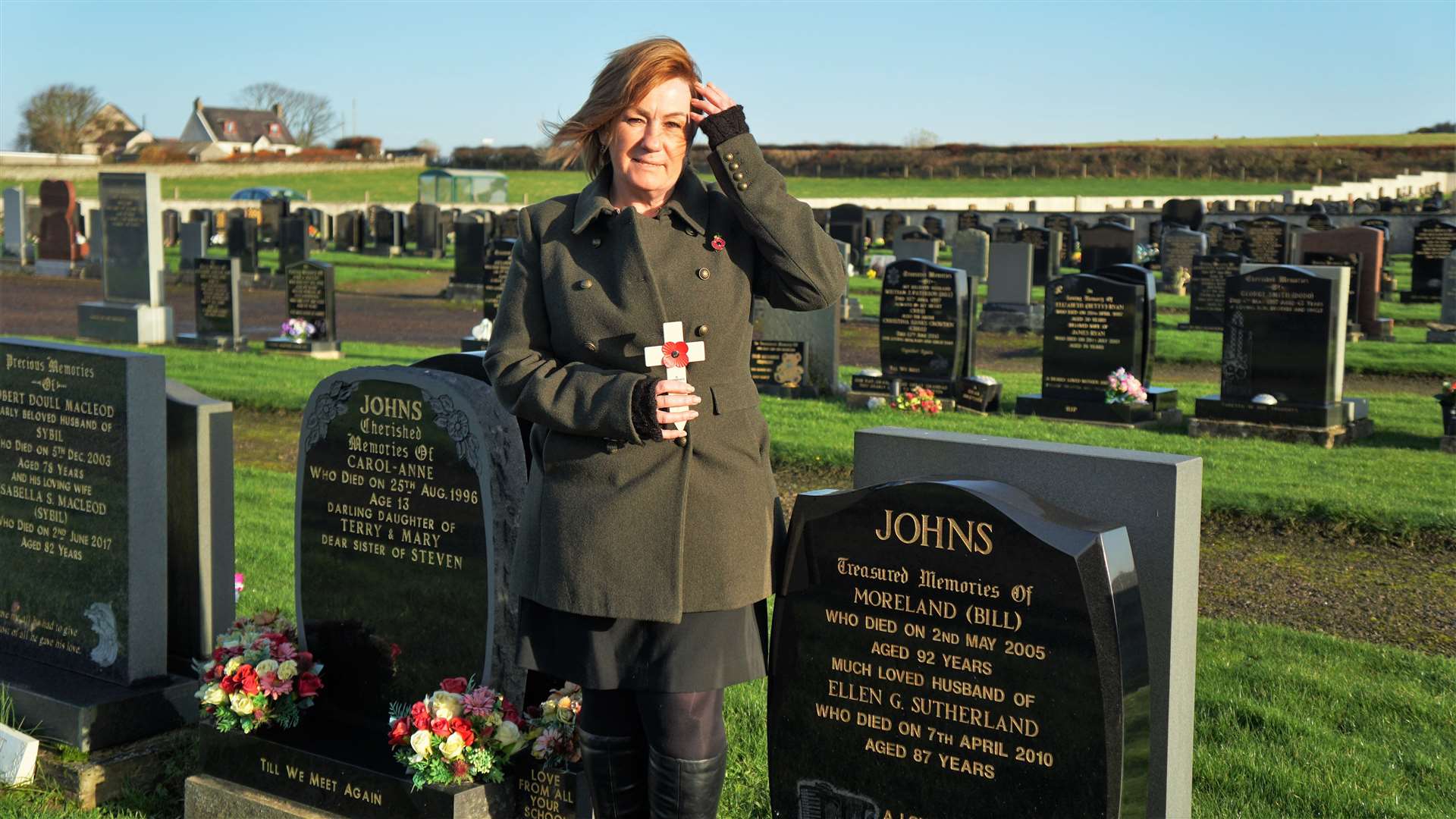 Linda Johns put a poppy cross on the grave of her late grandfather Bill Johns who she affectionately called 'Papa'. Picture: DGS