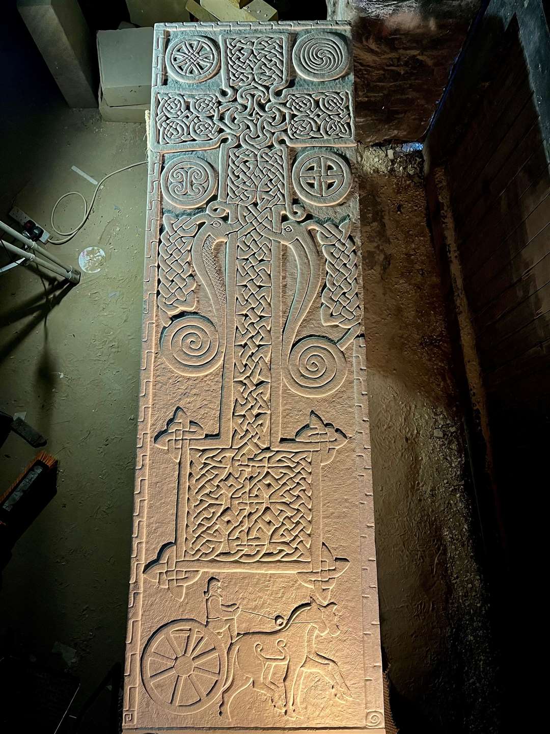 The new Skinnet Cross carved stone in David's workshop.
