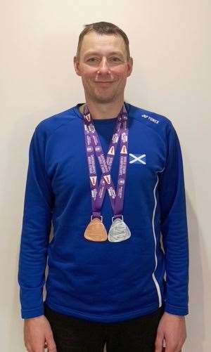 Mark Mackay with the silver and bronze medals he won at the international event in Huelva.
