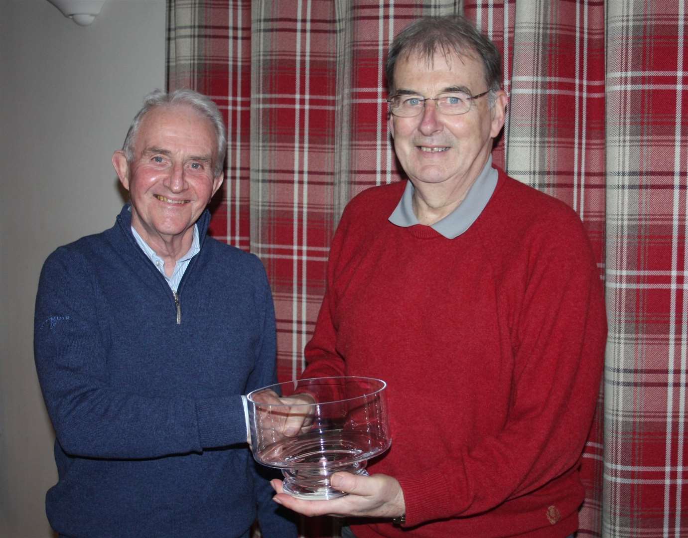 Jock Eunson (right) receiving a glass bowl from Fred Groves for his 25 years of service on the Reay Golf Club committee.