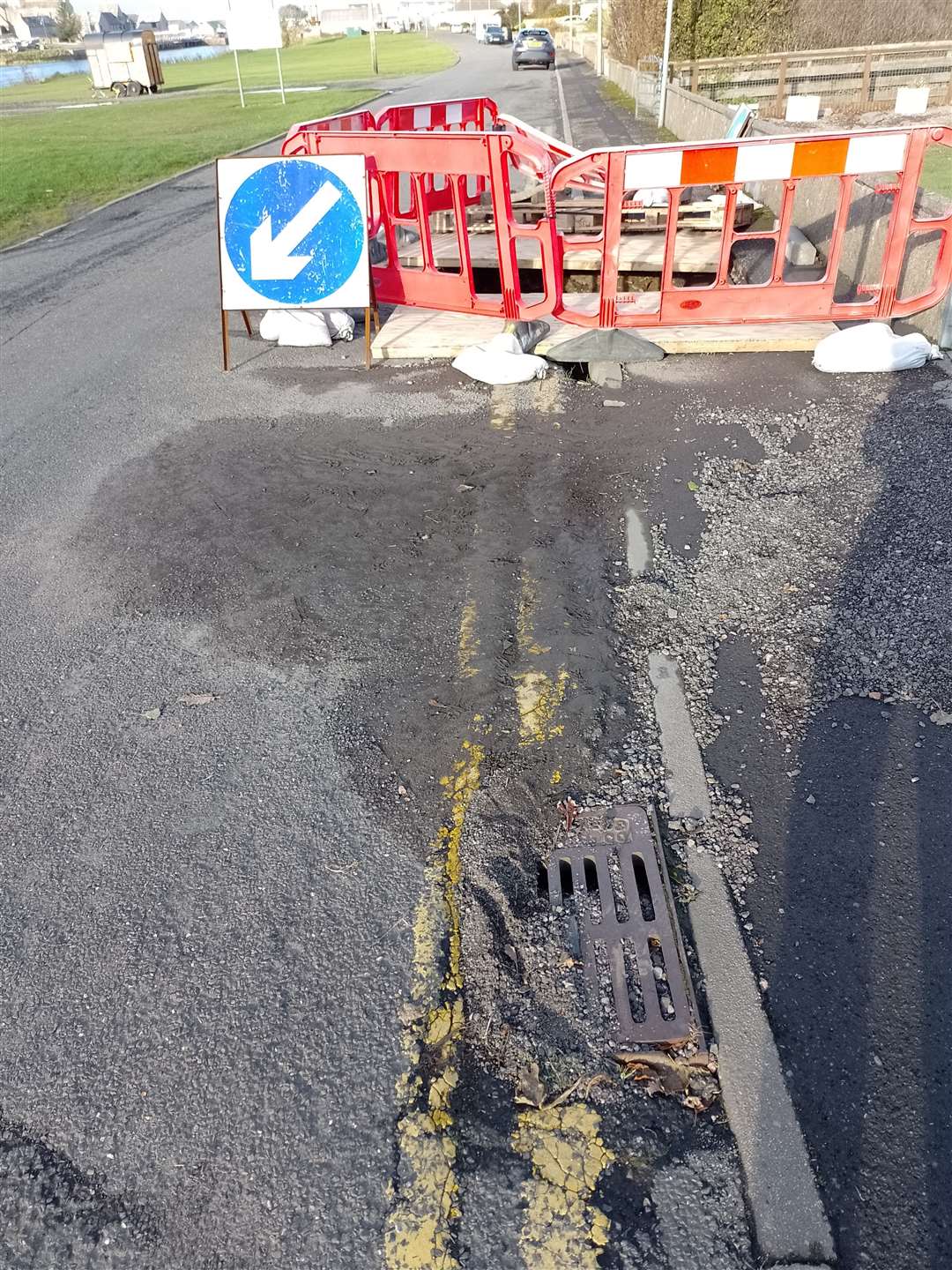 The pavement is blocked and missing where the original hole has been excavated.
