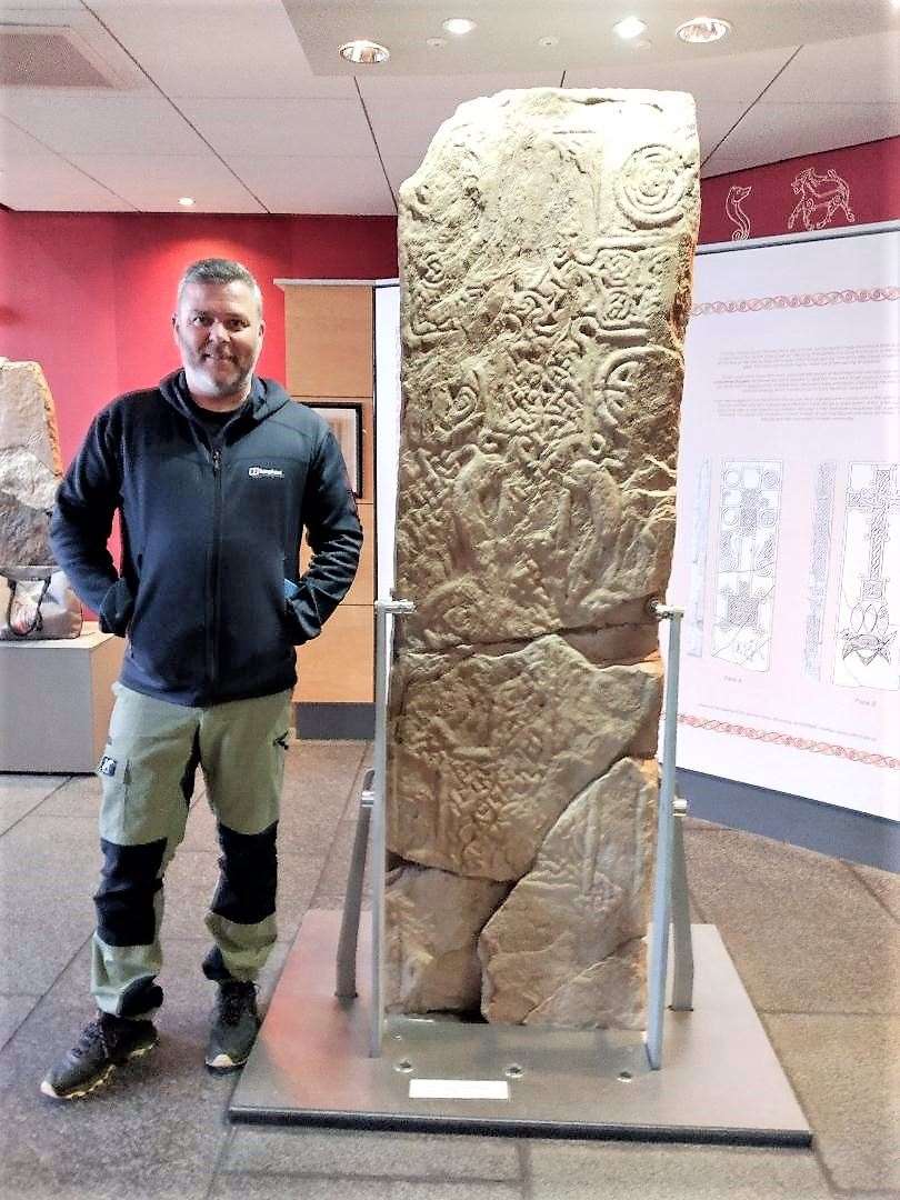David McGovern, stonemason, at the original Skinnet Stone in the North Coast Visitor Centre.