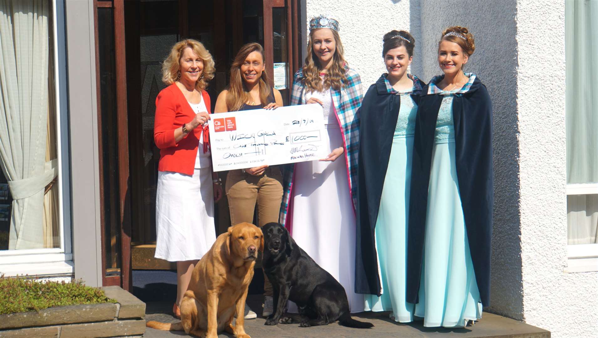 Mackays Hotel presented a cheque for £1000 to Wick Gala Week as a goodwill gesture. From left, Ellie Lamont and her daughter Jennifer Lamont from the hotel, gala queen Maja Pearson, and her attendants Sophie Green and Morven Coghill. Front row are the hotel dogs Max and Breagh. Picture: DGS