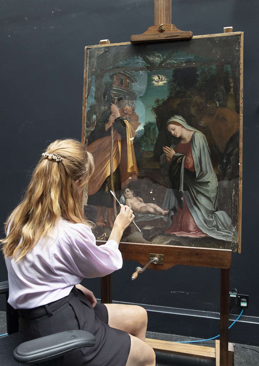 Conservation fellow Olivia Stoddart restoring Peruzzi’s Nativity (The National Gallery, London/PA)