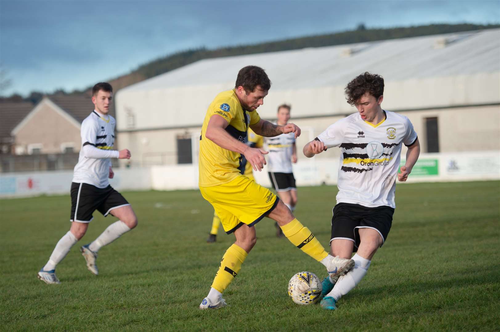 Wick Academy's Jack Henry is confronted by Aly Riddle of Clach. Picture: Callum Mackay