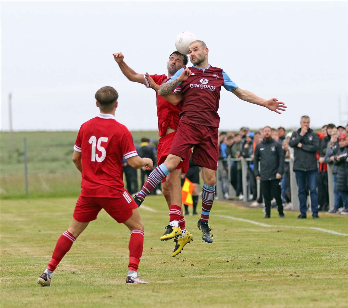 Pentland United defender Sean Munro in an aerial duel with Graham MacNab of Wick Groats. Picture: James Gunn