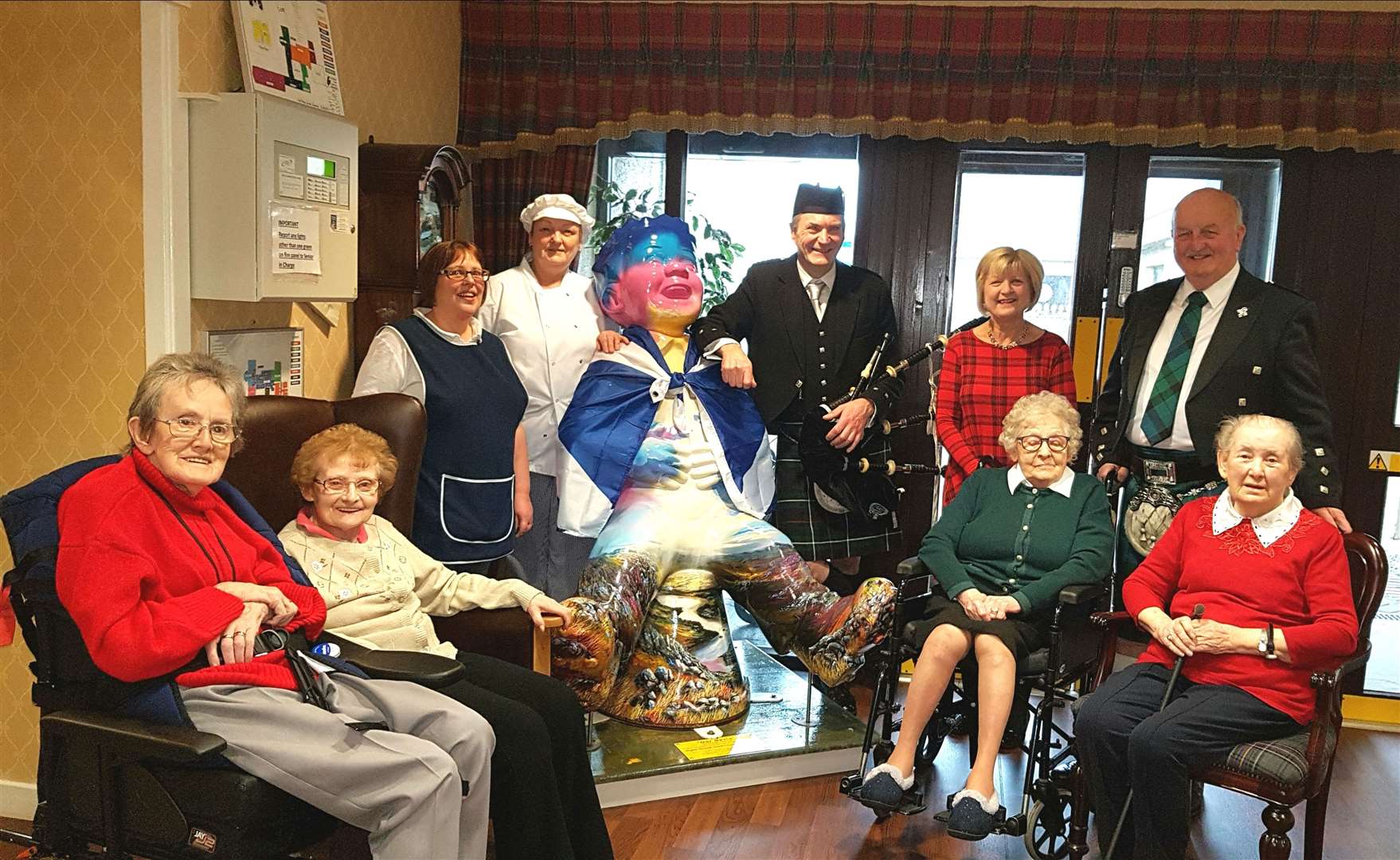 Some of the staff and residents at Pulteney House with Willie Mackay, piper Gordon Tait and Willie's wife Glynis.