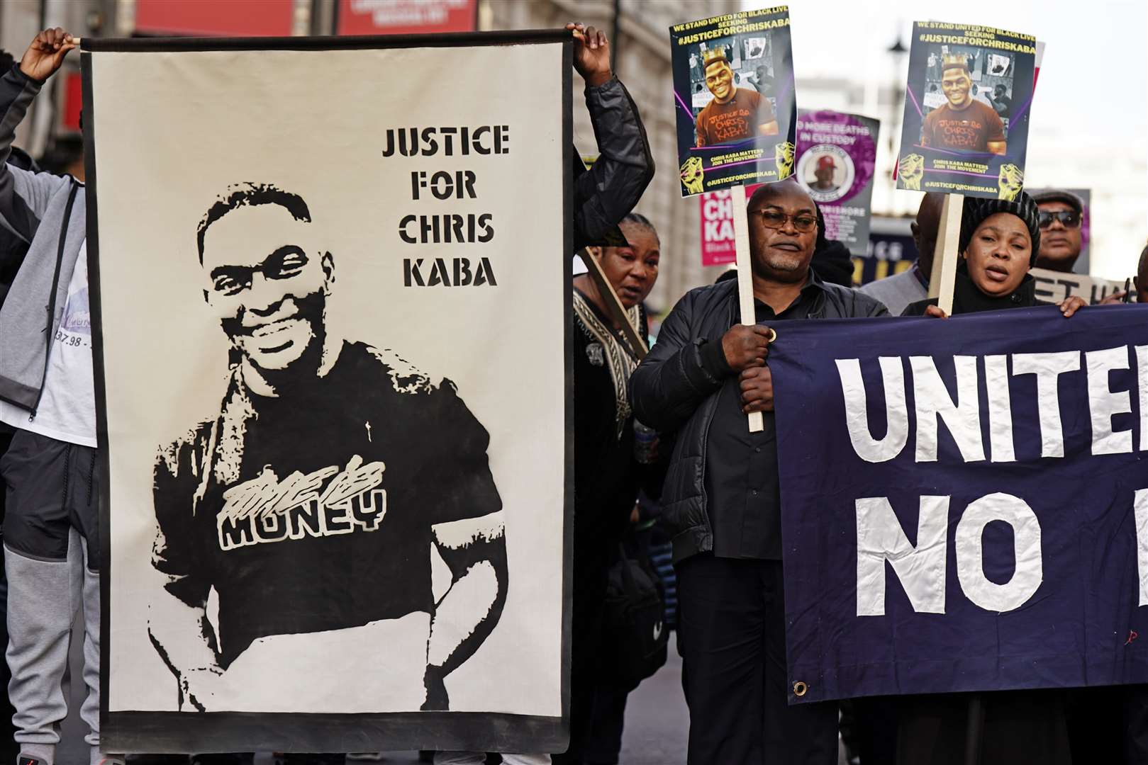 The protesters show a poster of Chris Kaba during the march (Aaron Chown/PA)