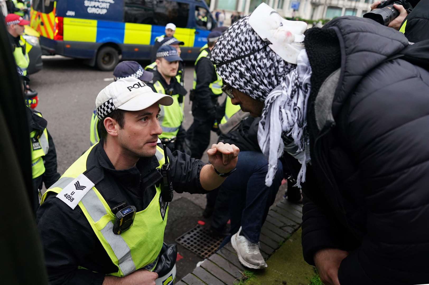 A police officer talking to a person taking part in a pro-Palestine march (Jordan Pettitt/PA)