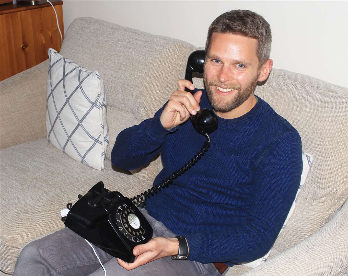 Chris Aitken calling up an oral history recording on the old-style phone.