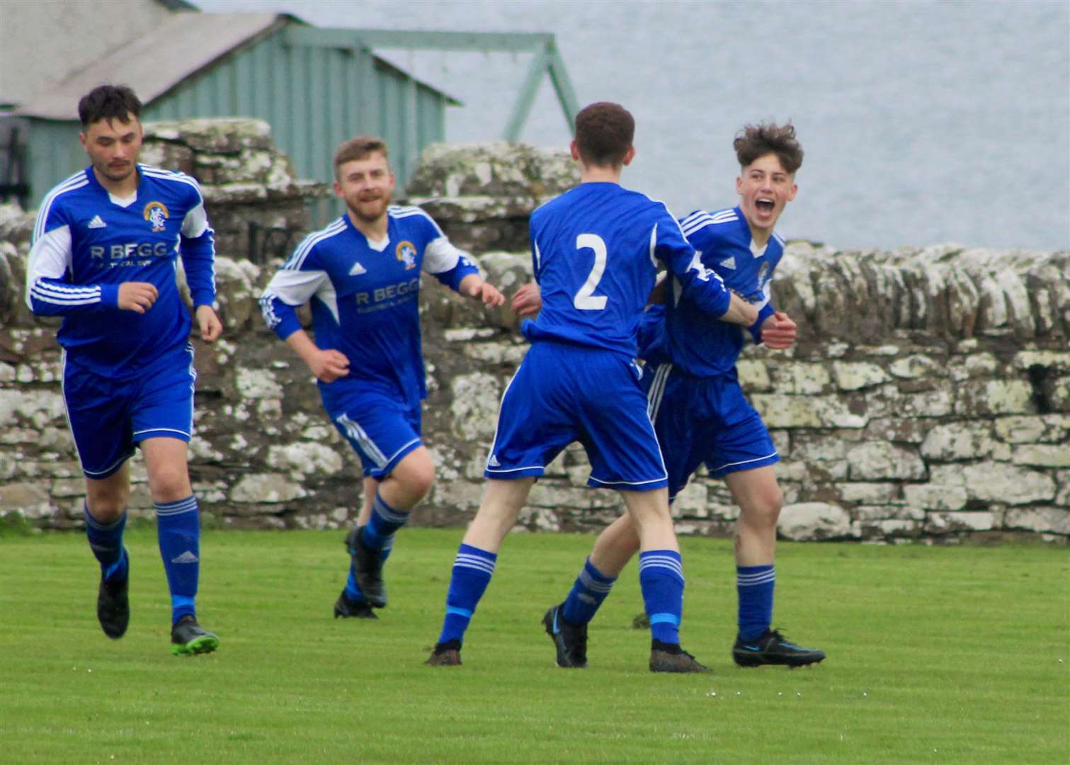 Lewis Gill (right) shows his delight after opening the scoring for Keiss.