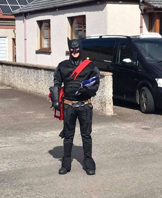 Paul Gunn donned a Batman suit to make his deliveries.