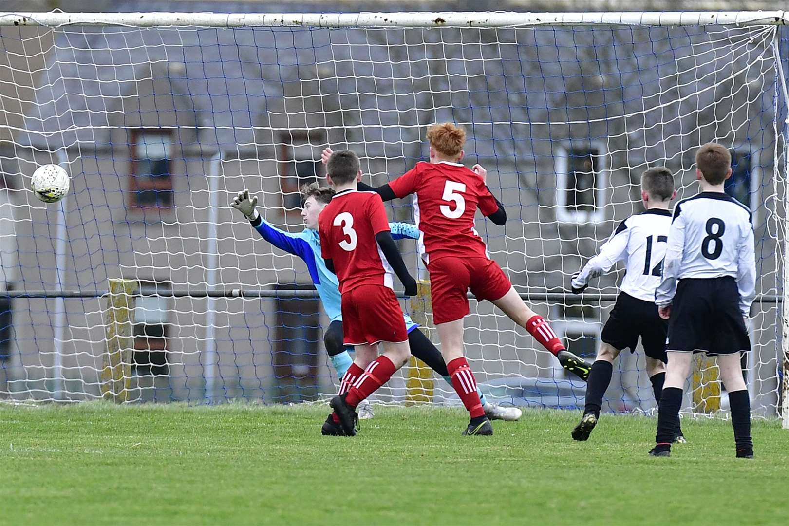 A shot from Scott Durrand beats visiting keeper Alex MacDonald to put Wick Academy under-15s two up against Do Soccer. Picture: Mel Roger