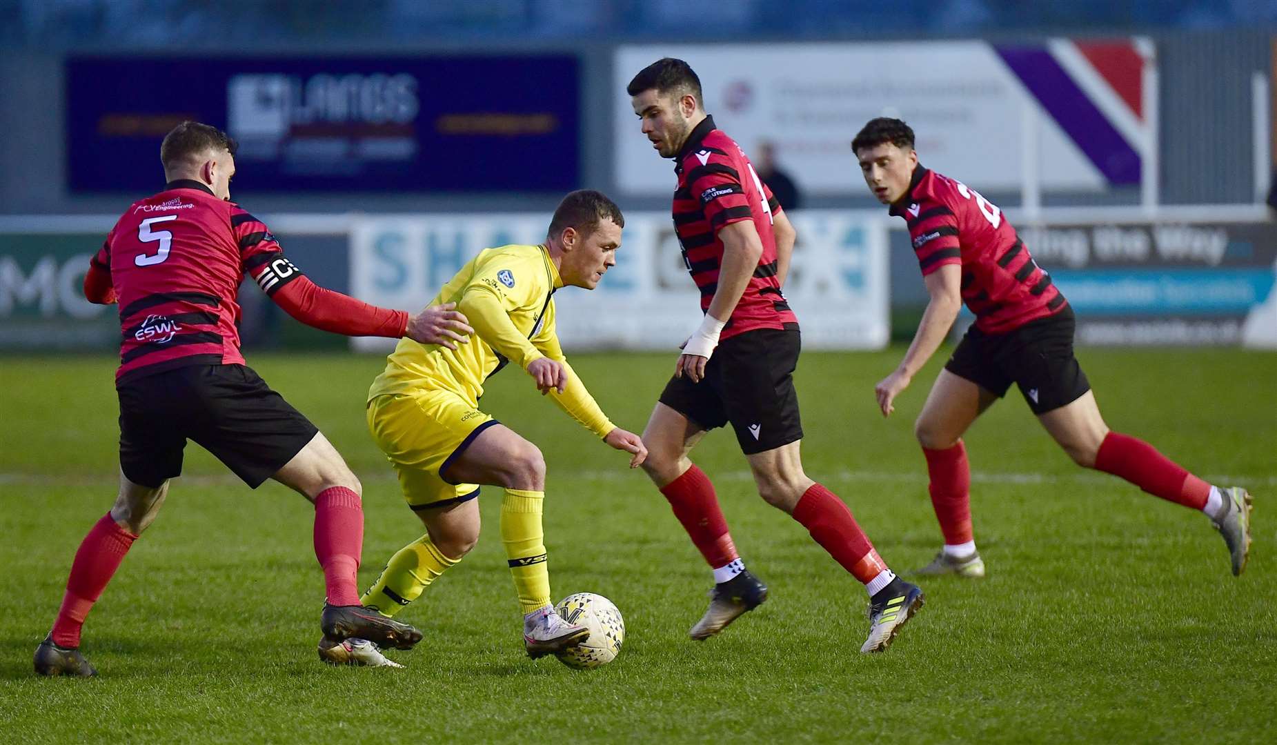 Gordon MacNab drives through a gap between Inverurie pair Mark Souter and Calum Dingwall. Picture: Mel Roger