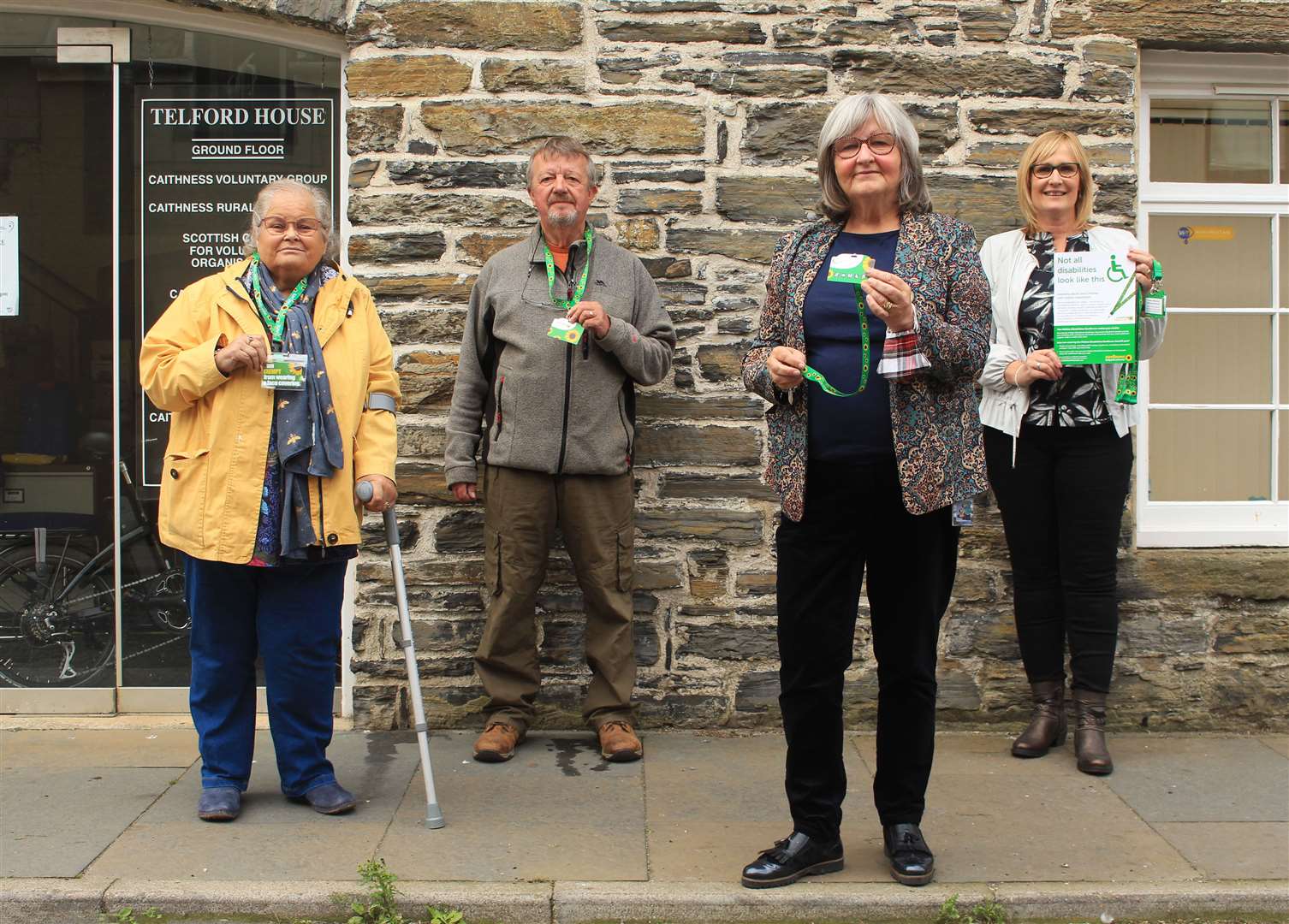 Caithness Disabled Access Panel's chairperson Helen Budge (left), treasurer John Niwa and secretary Jan McEwan with Hearing and Sight Care manager Deirdre Aitken (right) displaying the new lanyards. Picture: Alan Hendry