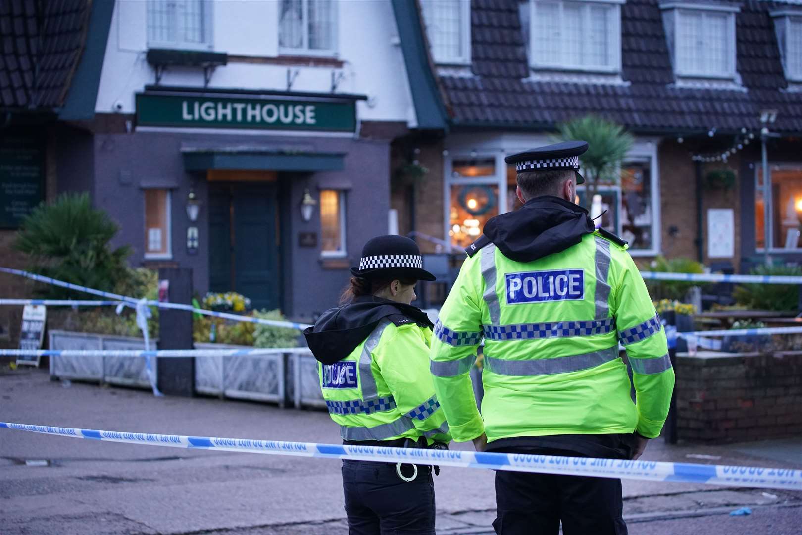 Police officers patrol the cordon outside the pub Wallasey Village (Peter Byrne/PA)