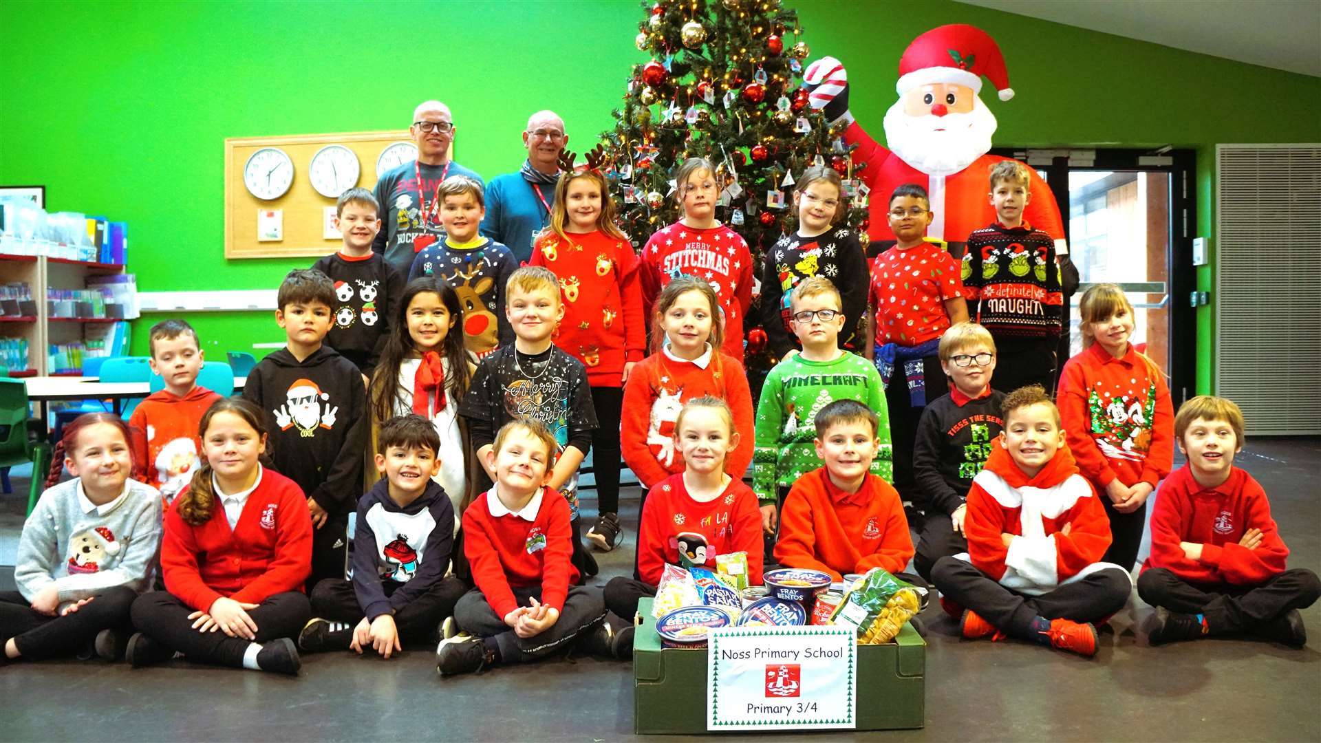 David Miller and Grant Ramsay with pupils at Noss Primary School in Wick who did a 'reverse advent calendar' which involved taking in a different item each day as a donation for Caithness Foodbank. Picture: DGS