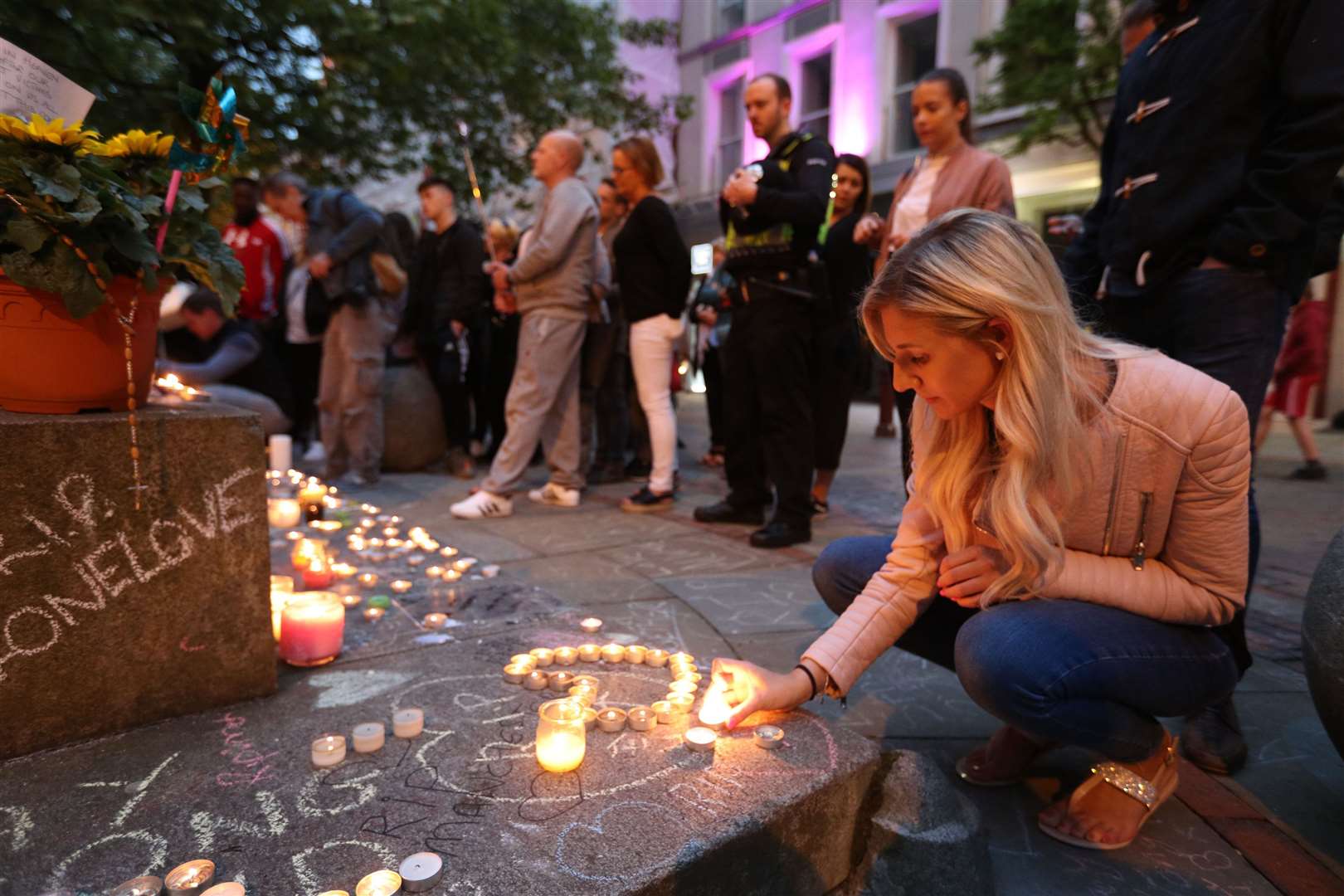Mourners view tributes in St Ann’s Square, Manchester (Jonathan Brady/PA)