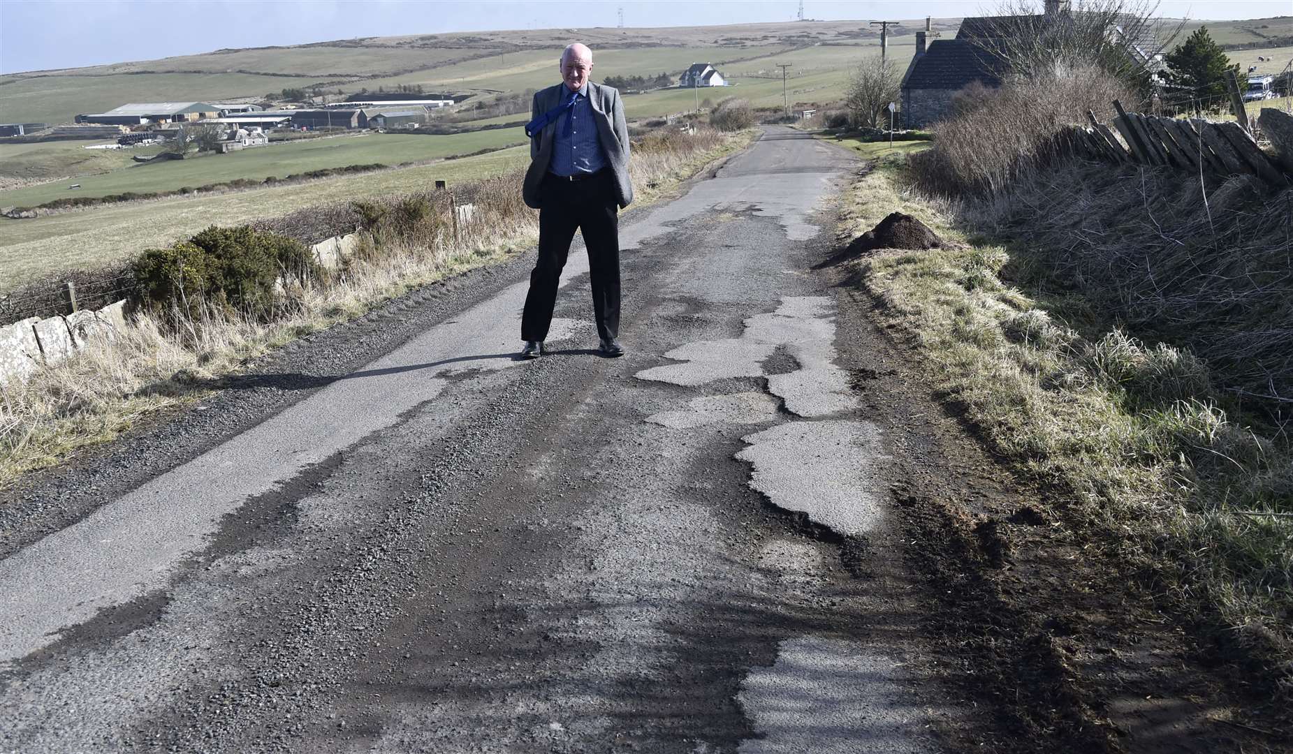 Iain Gregory of Caithness Roads Recovery standing on a damaged section of road at Sibmister. Picture: Mel Roger