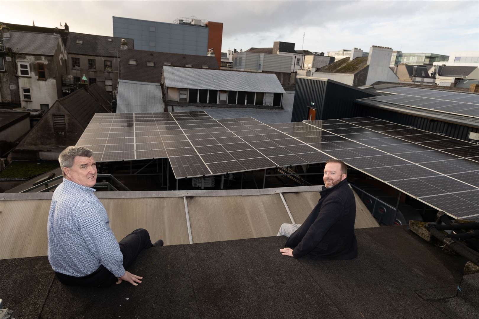 Kevin Cottrell and Eoin Aher with the solar panels on the roof of the The Old Oak in Cork (Darragh Kane/PA)