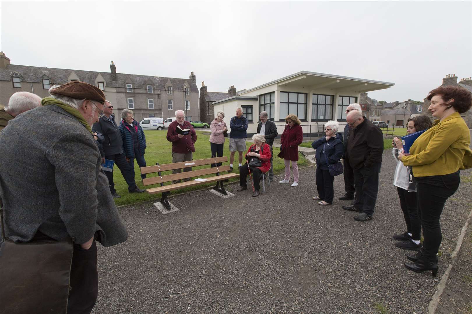 Drew Macleod (centre) reads a poem during the gathering at Wick's Braehead on Saturday afternoon to mark the 10th anniversary of the death of David Morrison. His daughter Glenna Scacchi and granddaughter Marilena, who travelled north for the ceremony, are on the right. Picture: Robert MacDonald / Northern Studios
