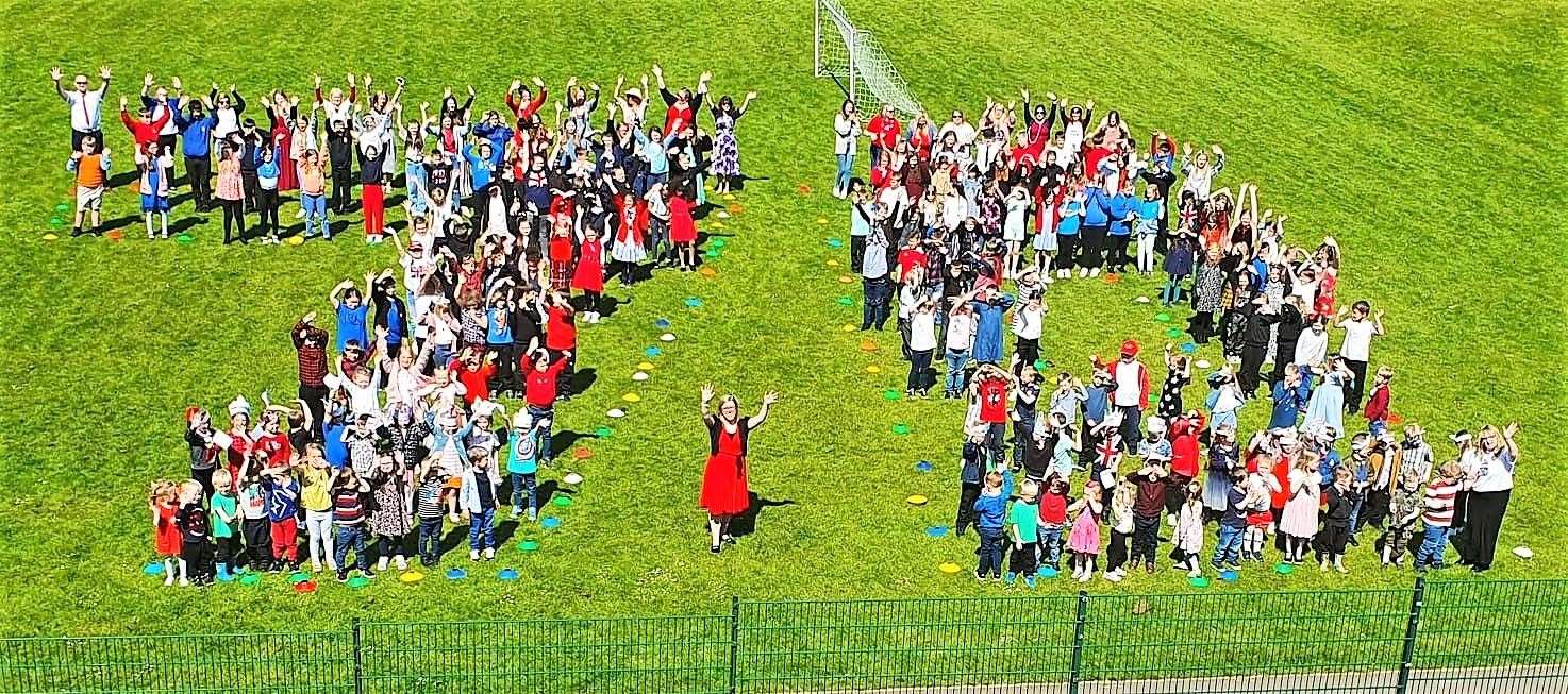 Staff and pupils at Mount Pleasant Primary School get their sums right for this spectacular aerial shot as they form the number 70 for the Queen's Platinum Jubilee celebration.