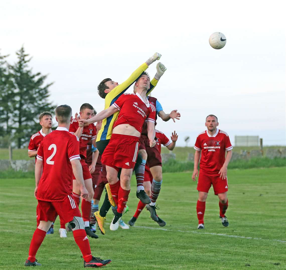 Wick Groats goalkeeper Kieran Macleod punches clear from a Pentland United attack. Picture: James Gunn