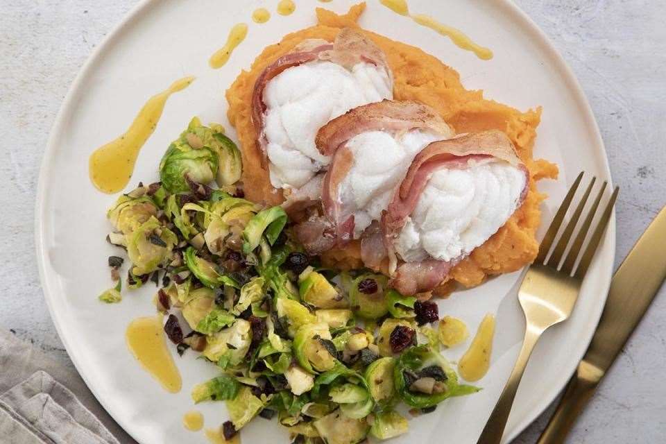 Roast monkfish wrapped in bacon with shredded sprouts and sweet potato mash.